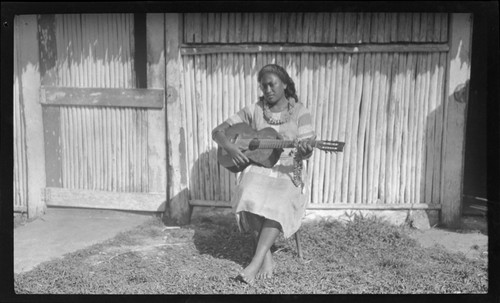 Young Cook Islands woman with guitar