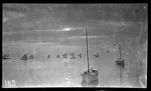 Boats at sea, canoes with sails