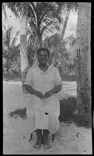 Woman sitting on chair at beach