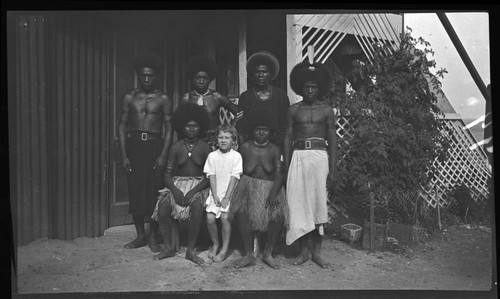 Lambert's Motu assistants, with two women and a young European girl