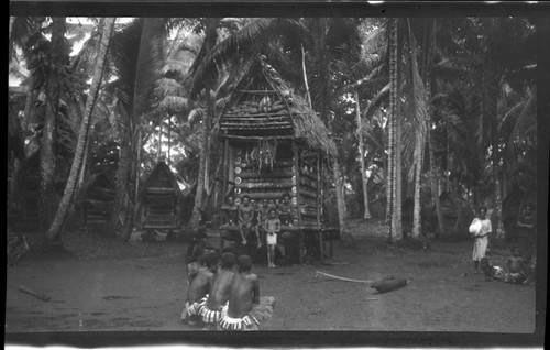 People around a yam house, Trobriand Islands