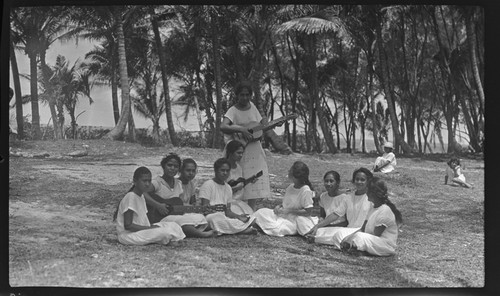 Cook Islands girls playing music, some with guitars