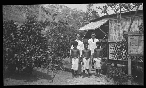 Mining company manager, E. Hogan Taylor and solicitor, Robert Dugald Bertie with three Papua New Guinean boys, probably in Port Moresby