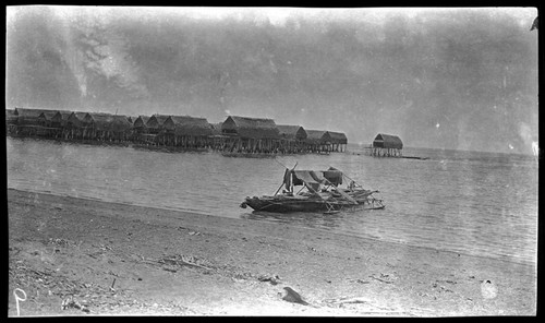 Canoe, and houses on stilts at Tupuseleia, a Motu village