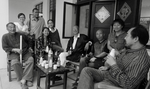 A group of Chinese artists and friends at small gathering in the courtyard of house in Dali