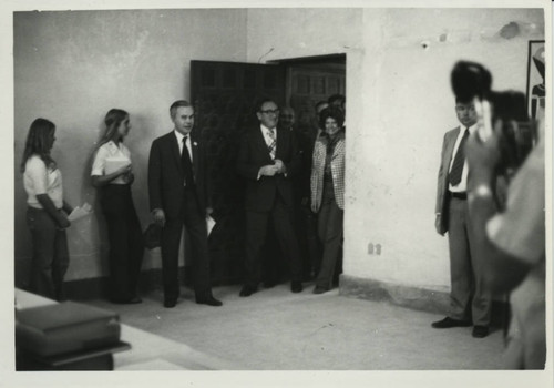 Henry Kissinger enters a room at the Coptic Museum