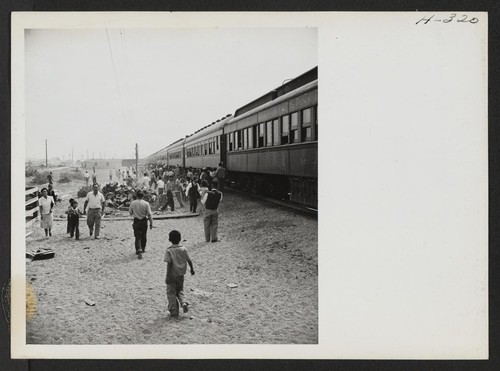 Time out for exercising. Each segregation train, when possible, paused for 10 or 15 minutes at some railroad siding to allow the passengers to detrain and limber up. Photographer: Mace, Charles E