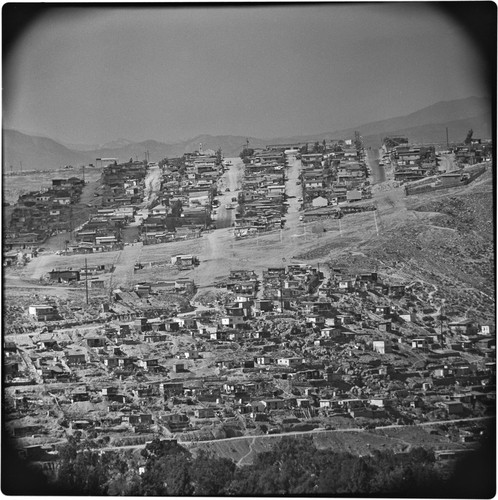 Hillside on the east side of the Tijuana River Valley. Subdevelopment at the top of the photograph, on the edge of Mesa de Otay. Below are irregular settlements