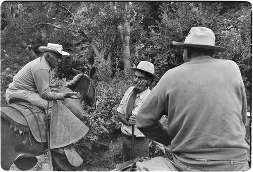 Tacho Arce, left, exchanging gossip with rancher at Rancho San Nicolás