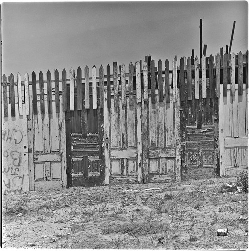 Wooden fence made from old doors and used lumber