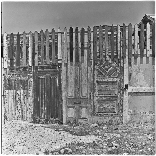 Wooden fence made from old doors and used lumber