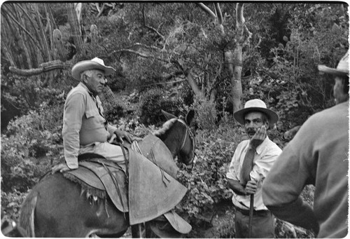 Tacho Arce, left, exchanging gossip with rancher at Rancho San Nicolás