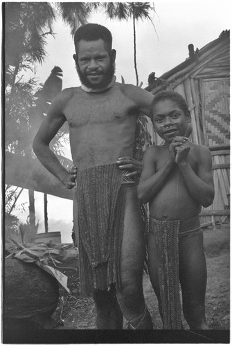 Man and boy stand next to Rappaport's house