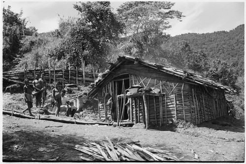 People outside kitchen next to the Rappaports' house, Tsembaga