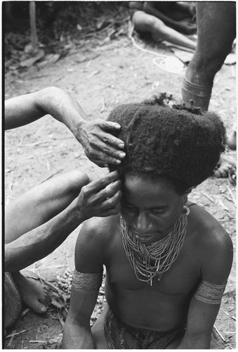 Pig festival, wig ritual, Tsembaga: man's hair is pulled over wig frame