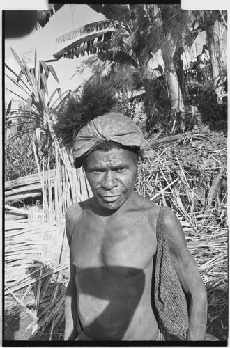 Man with barkcloth cap and netbag