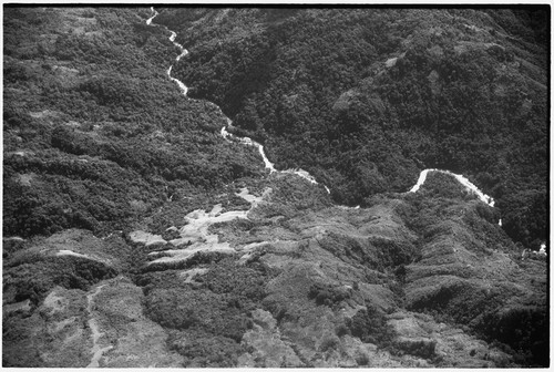 Aerial view of mountains, river, trails and garden clearing