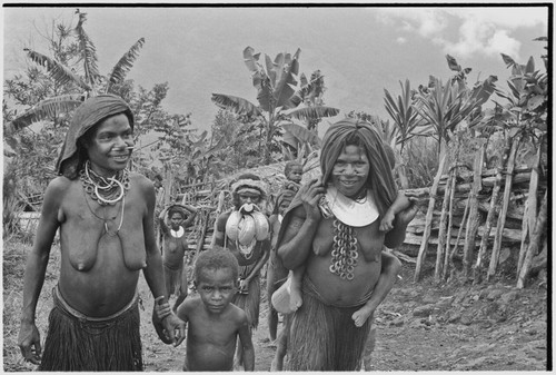 Bride price ritual: bride (wearing large shell valuables) walks behind other women