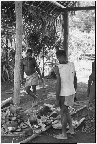 Ambaiat: distribution of pork from pig killed for damaging garden, supervised by pig's owner, Ausandar (in shirt)