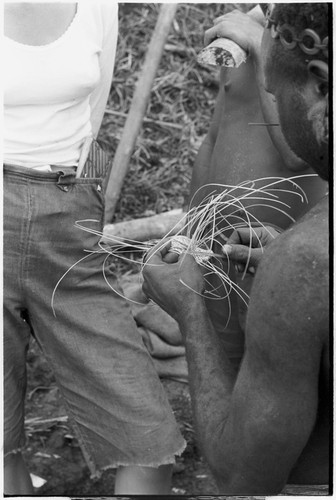 Weaving: an armband is intricately woven from orchid fibers