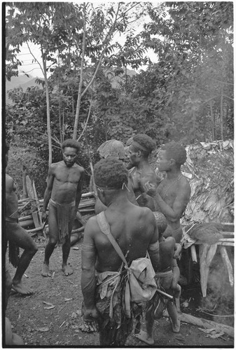 Dispute in Tuguma: men discuss garden damage done by a neighobring group's pig