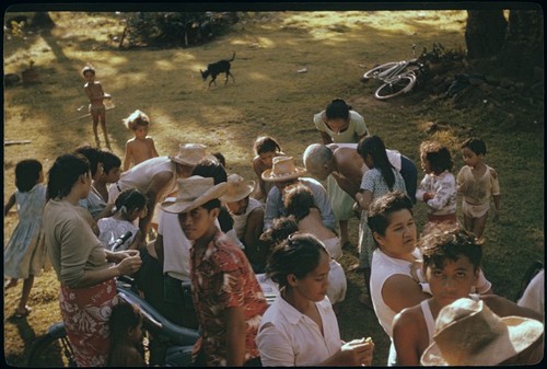 Local people at archaeology exhibit, examining drawings, Moorea