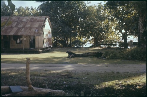 Road and house built with corrugated metal, Papetoai, Moorea