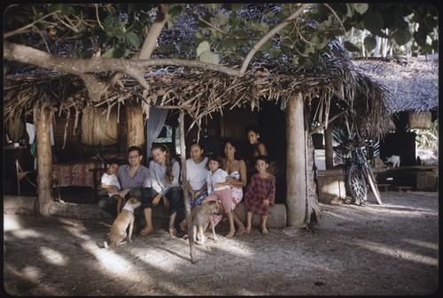 Ann and Roy Rappaport with Poia's family in an open-sided house, Moorea
