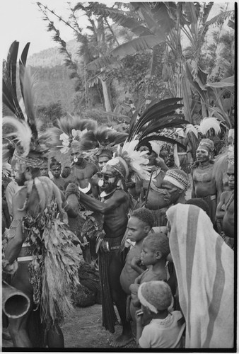 Pig festival, singsing, Kwiop: decorated people and spectators watch dance, man with sun glasses