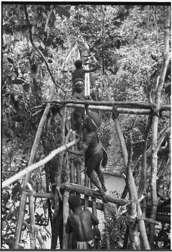 Bridge-building: two sides of bridge start to meet, fastening railings to deck