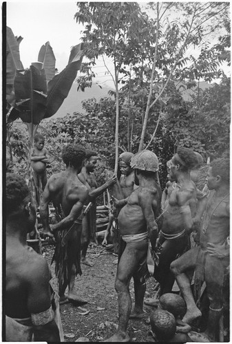 Dispute in Tuguma: men discuss garden damage done by a neighboring group's pig