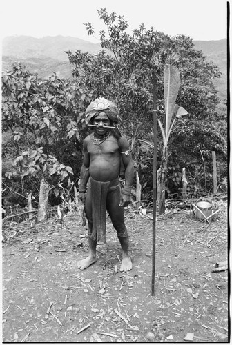 Timothy Akis, translator for the Rappaports, with decorated barkcloth cap and spear