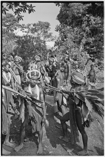 Pig festival, stake-planting, Tuguma: decorated Tsembaga men with ritual items to expel enemy spirits and establish boundary