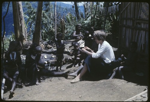 Ann Rappaport with women and children, Rappaports' house on right