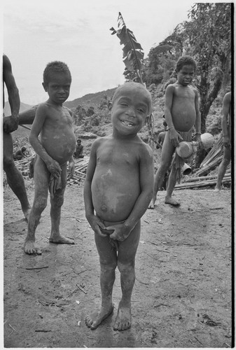 Young children, one with kundu drum