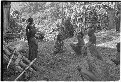 People cut grass around government rest house in Tsembaga, anticipating visit of patrol officer