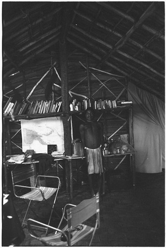 Rappaports' house: Inawe at east wall of house's interior, desk with books, map