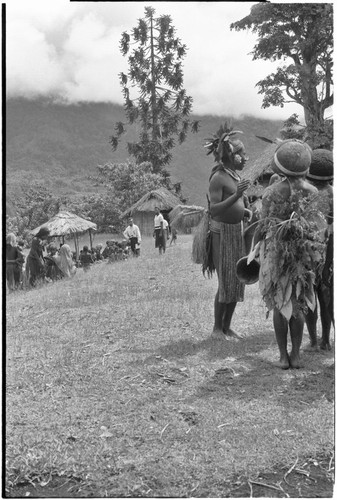 Church service in Tsembaga: decorated men prepare to dance at service held by Solomon Islander Anglican missionaries