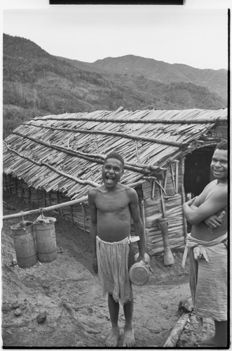 Pig festival, singsing preparations, Tsembaga: men with kundu drum and bamboo mouth harp