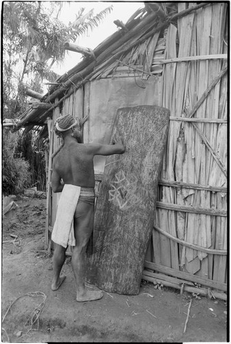 Shield: Piat paints design on shield at Rappaport's house