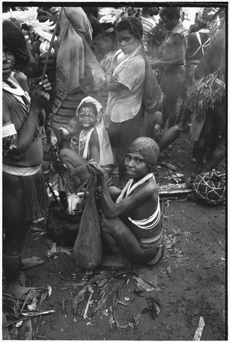 Pig festival, pig sacrifice, Tsembaga: women, some with netbags, on dance ground where exchanges are taking place, wig on right