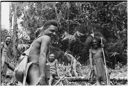 Gardening: group of laughing men clear garden