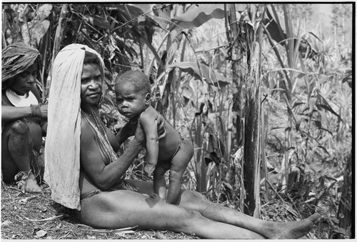 Mother and infant, woman with kina shell pendant