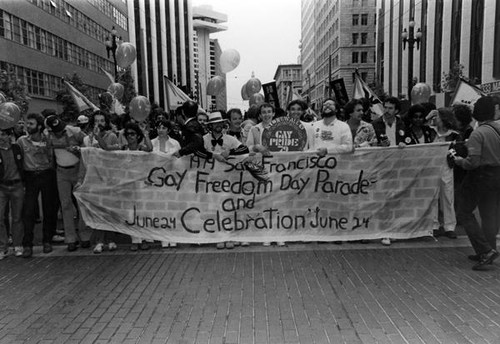 Freedom Day parade participants holding a banner