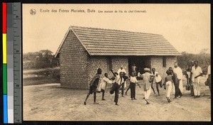 Missionary fathers and boys gathered outside of a brick building, Congo, ca.1920-1940