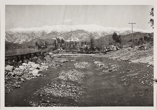 Flood picture from 1969. View of mountains, depicting wash. Backhoe in distance