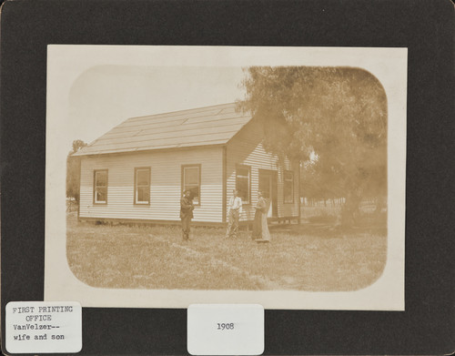 Mr. & Mrs. Van Velzer and son at the printing office, 1908