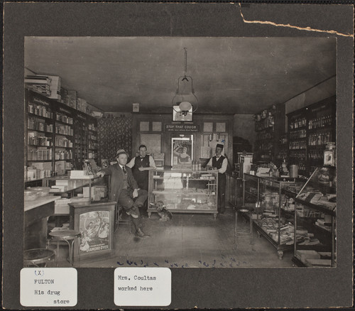 Robert Fulton's Drugstore. Mr. Fulton is at right, behind the glass case