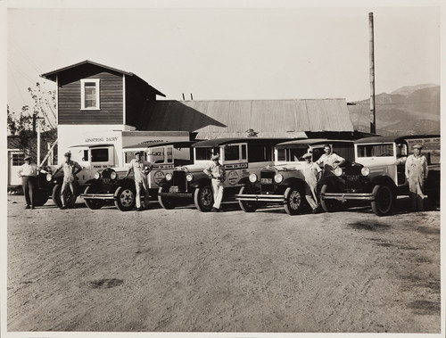 Armstrong Dairy, men in front of dairy with trucks, 1932