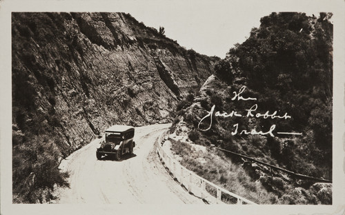 Postcard of old time car driving on Jack Rabbit Trail